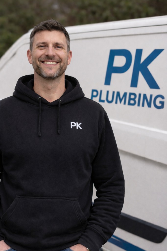 Professional plumber from PK Plumbing with company van in your area